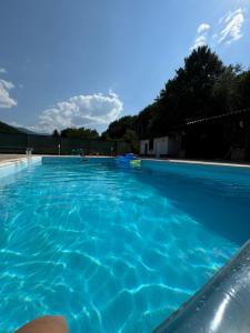 a swimming pool with blue water at Sarajevo Deluxe penthouse and pool in Sarajevo