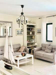 a living room with a model boat on a coffee table at Apartment Tri Kiparisa in Tivat +17 photos