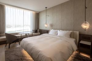 En eller flere senge i et værelse på ATAGO HOTEL