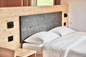 Postel nebo postele na pokoji v ubytování Hotel Garni Civetta + 37 fotografií