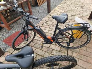 a bicycle is parked on a brick ground at B&B Majhen in Kopačevo