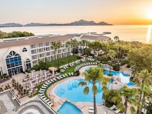 an aerial view of the resort with a pool and beach at Grupotel Parc Natural & Spa in Playa de Muro