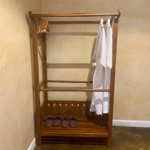 a wooden closet with shoes and white clothes at 17Stories 2 in Pai +34 photos
