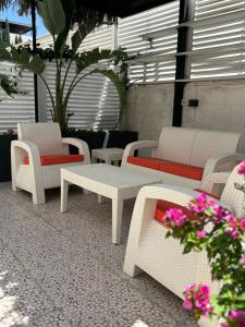 a group of chairs and tables on a patio with flowers at Seas Hotel Amman in Amman