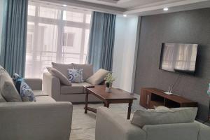 a living room with two couches and a table at Luxurious 3br Condo with sea views in Nyali,Pool,Lift in Mombasa