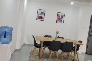 a dining room table with black chairs at Luxurious 3br Condo with sea views in Nyali,Pool,Lift in Mombasa +30 photos