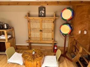 a room with a table and chairs in a room at Arirang Hanok Stay in Daegu