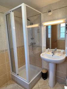 a bathroom with a shower and a sink at Logis Hôtel Restaurant SPA Le Tosny in Épaignes +6 photos
