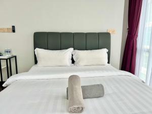 Postel nebo postele na pokoji v ubytování Margo Hotel Kota Kinabalu