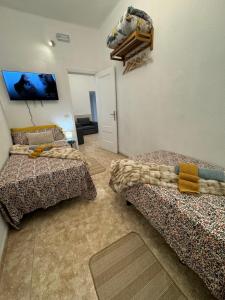 a room with two beds and a flat screen tv at Dream Laguna 3 in La Laguna