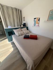 a bedroom with a large bed with a red blanket at La Casa del Roc in Sainte-Colombe