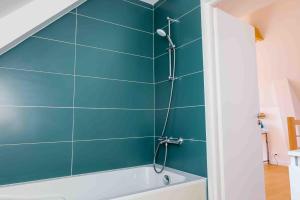 a bathroom with a shower with a tub at À 490m de la plage, maison neuve pour 8 in Trébérouant +31 photos