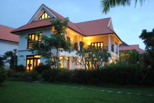 a white house with a dark roof at Furama Villas Danang in Danang