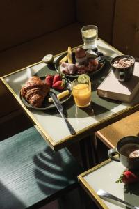 a tray of breakfast foods on a table at Hotel Orphée - Orso Hotels in Paris