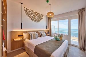a bedroom with a bed with a view of the ocean at Sauló by Puro in Can Pastilla
