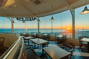a restaurant with tables and chairs and a view of the ocean at Kensington Resort Seorak Beach in Sokcho