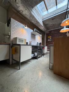 a large room with a kitchen with a ceiling at Sleep You Soon - Loft & parking in Liège +10 photos