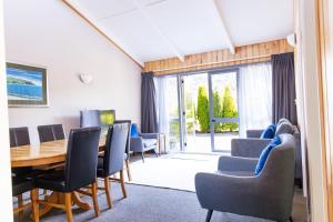 a dining room with a table and chairs at Apostles View Motel in Greymouth