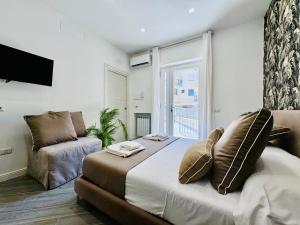 a bedroom with a large bed and a couch at YourHome - Santa Lucia Rooms in Sorrento +13 photos