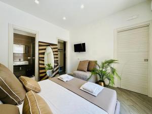 a bedroom with a large bed and a couch at YourHome - Santa Lucia Rooms in Sorrento
