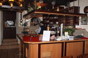 a man sitting at a bar in a restaurant at Norling Guest House in Vienna