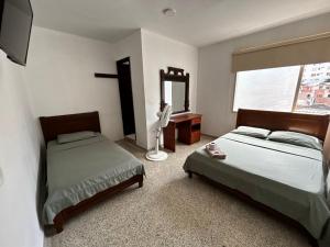 Postel nebo postele na pokoji v ubytování Hotel el Recuerdo + 7 fotografií