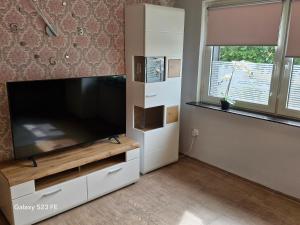 a living room with a large flat screen tv at Apartment Bochum in Bochum