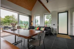 a dining room with a table and chairs at Hello Zeeland - Vakantiewoning Kalfhoeksepad 8 in Aagtekerke