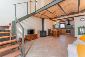 a large room with a staircase and a living room at Casa Rural Catalina in Camañas