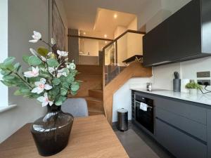 a vase with flowers on a table in a kitchen at Luxurious Studio - Central Prime Reading Location- CHRL F18 in Reading