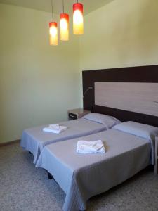 Postel nebo postele na pokoji v ubytování Hotel Sabatino