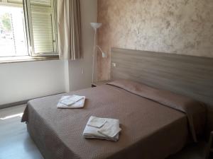 Postel nebo postele na pokoji v ubytování Hotel Sabatino