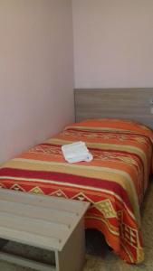 Postel nebo postele na pokoji v ubytování Hotel Sabatino