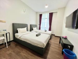 Postel nebo postele na pokoji v ubytování Margo Hotel Kota Kinabalu