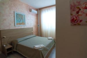 Postel nebo postele na pokoji v ubytování Hotel Sabatino