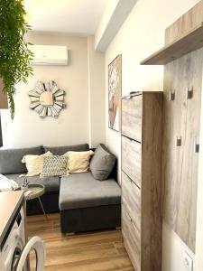 a living room with a couch and a table at Darius Lux Apartments in Paralia Katerinis