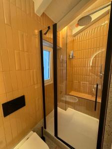 a bathroom with a glass shower and a toilet at Tosini's Home in Sale Marasino +19 photos