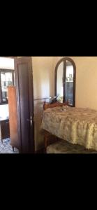a room with a bed and a mirror and a table at El Mirador del Convento San Juan de Morañina in Bollullos par del Condado