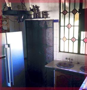 a kitchen with a refrigerator and a counter top at El Mirador del Convento San Juan de Morañina in Bollullos par del Condado