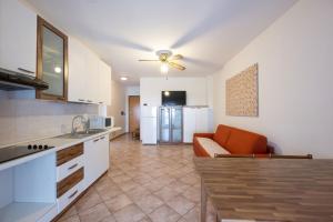 a kitchen with an orange couch in a room at Residence Desiree in Riva del Garda