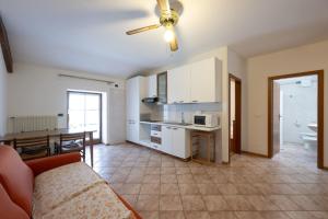 a kitchen and living room with a couch and a table at Residence Desiree in Riva del Garda