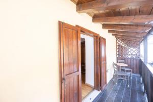 an open door to a balcony with a table and chair at Residence Desiree in Riva del Garda