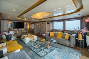 a living room with a couch and a table at iRama Luxury Superyacht 6 Cabins & Hot Tub & Water Toys in Cannes