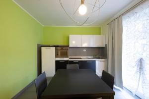 a dining room with a table and a kitchen at Residence Desiree in Riva del Garda