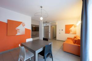 a dining room with a table and a couch at Residence Desiree in Riva del Garda