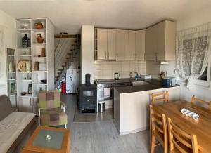 a kitchen and living room with a table and a couch at Vikendica Nature park Banja Luka in Banja Luka