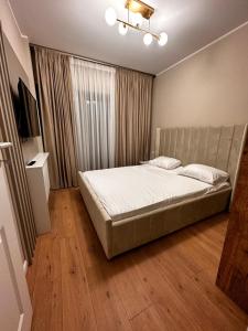 a bedroom with a large bed in a room at Luxury apartament in Mamaia Nord +4 photos