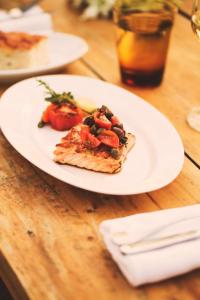 a slice of pizza on a white plate on a table at Hyatt Regency Chennai in Chennai