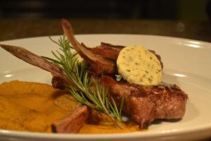 a plate of food with meat and potatoes and butter at Hyatt Regency Chennai in Chennai