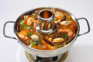a pot of soup with shrimp and other vegetables at Hyatt Regency Chennai in Chennai